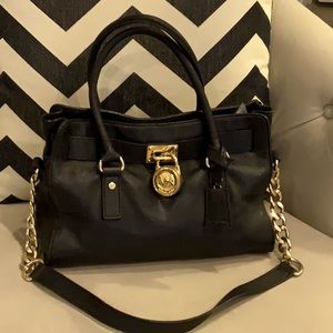 Michael Kors Leather Satchel with Lock handbag with detachable shoulder strap.